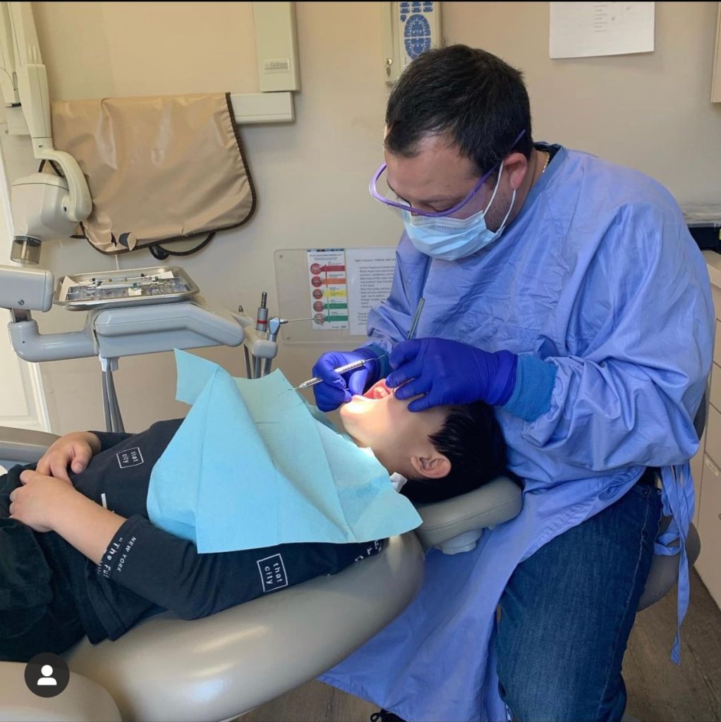 dentist performing dental treatment