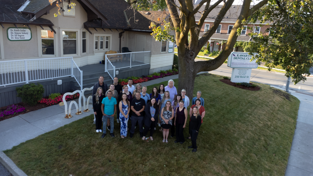 Doctors and staff of Kawartha Dental Clinic in front of the office.